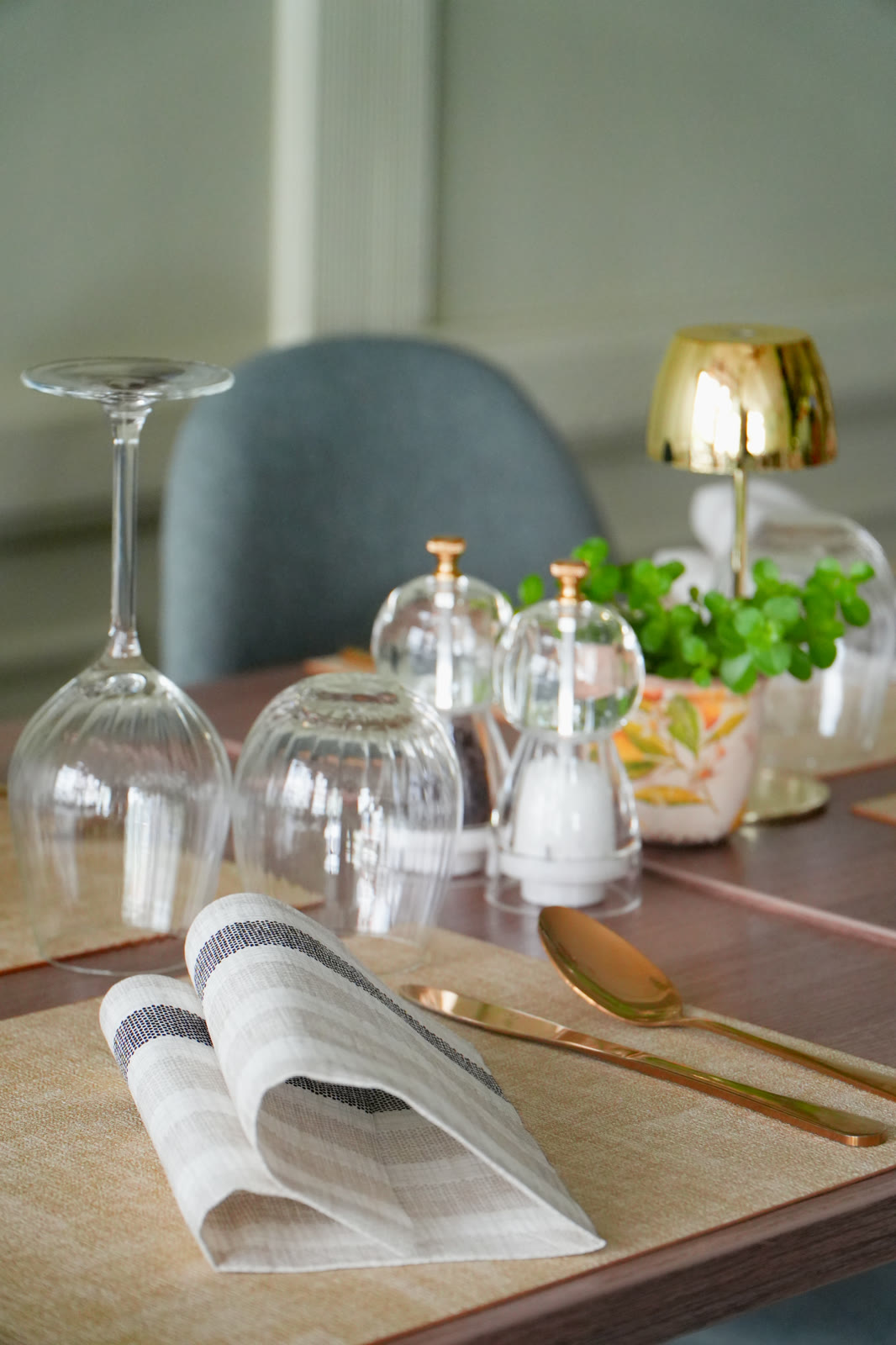 Table setting with glasses, gold cutlery and napkin at A Tavola