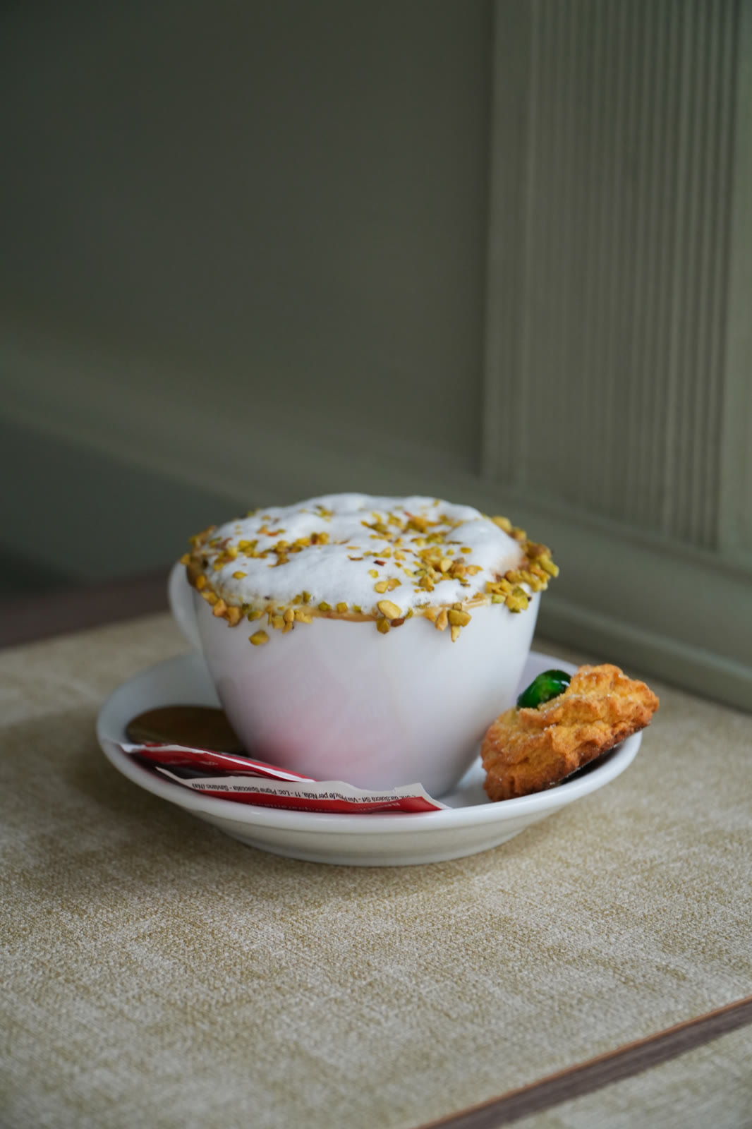 Pistachio cappuccino and biscuit at A Tavola Ristorante