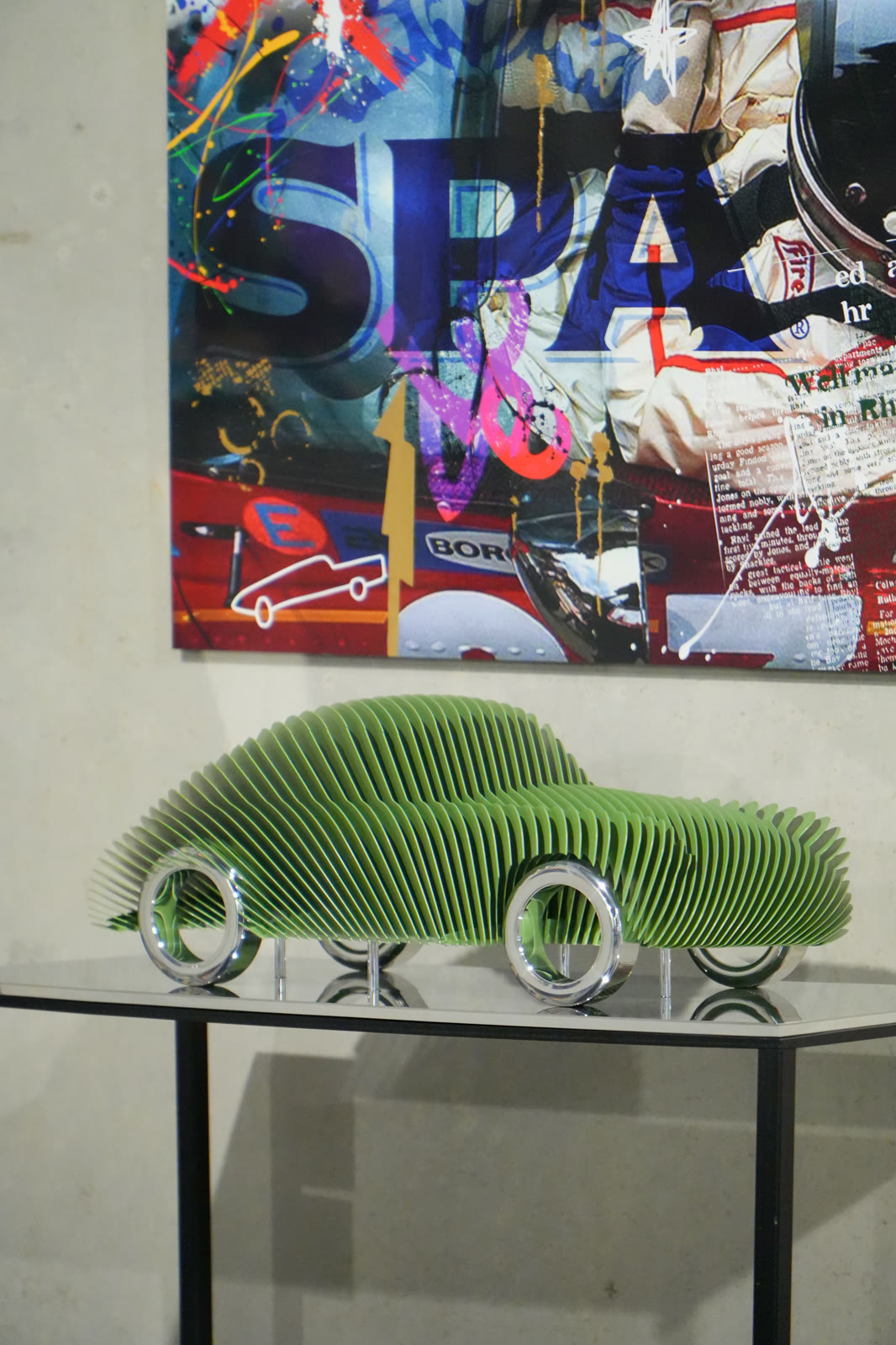 Green slatted car sculpture in front of a pop art canvas, Galleria 610