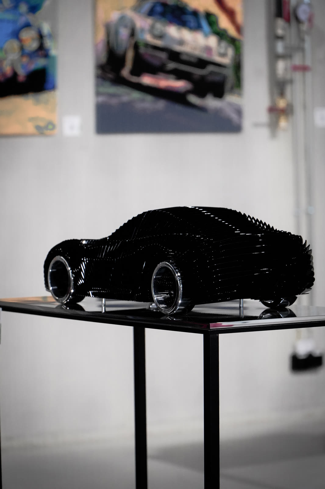 Black car sculpture and automotive paintings, Galleria 610